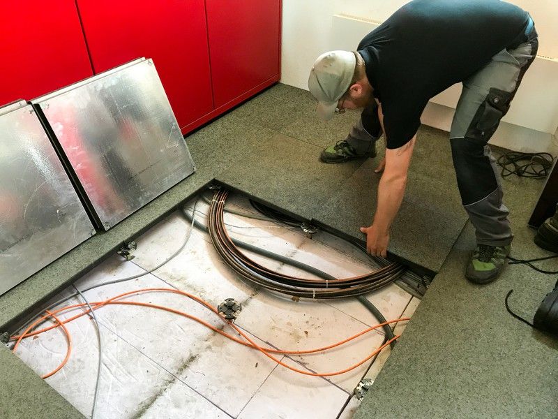 Electrical professional laying cables under the floor
